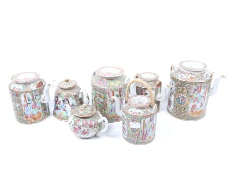 Seven famille rose teapots. c.1860-70, the panels decorated with birds and figural scenes, some with wire handles. Max. H16cm