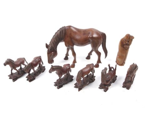 Seven boxwood horse figures and a boxwood netsuke. The horses in a variety of poses and including a larger example. Max. H17c