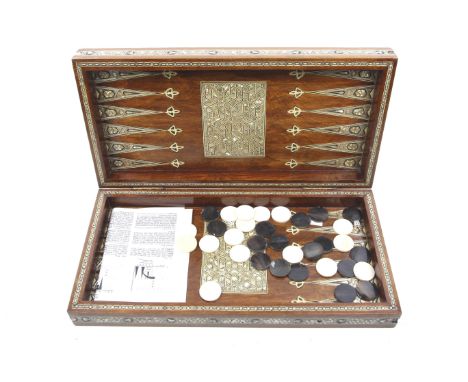 An Egyptian backgammon set and games box. The box doubling as a backgammon board and chessboard, inlaid with mother of pearl 