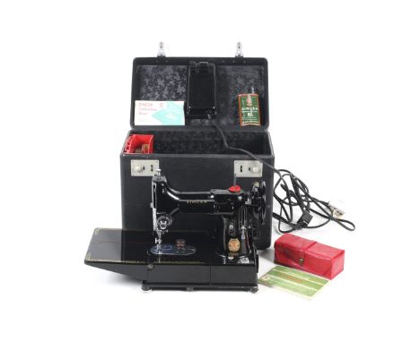 A vintage 20th century Singer Featherweight 222k sewing machine. The machine in the original case, with pedal, a collection o