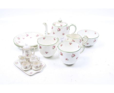 A Crown Staffordshire tea service for two and a miniature dolls house tea set. The Staffordshire set comprising a teapot, two