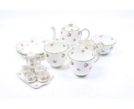 A Crown Staffordshire tea service for two and a miniature dolls house tea set. The Staffordshire set comprising a teapot, two