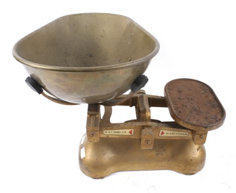 A vintage set of grocer's weighing scales. By W & T Avery Ltd of Birmingham, with a mat gold finish. Width of base circa 33cm