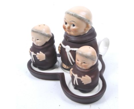 A German Goebel three piece cruet set with stand. Modelled as monks, marked 'M42' to the undersides, H10cm
