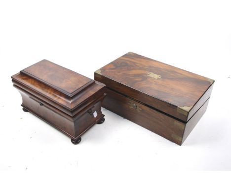 A Victorian mahogany tea caddy and a walnut writing slope. The tea caddy of bombe sarcophagus form, the interior with two com