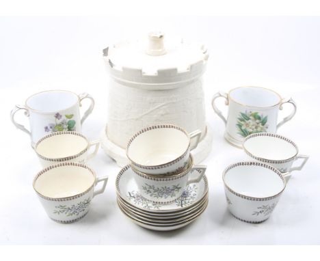 An assortment of vintage china. Incuding a castellated cheese bell modelled as a folly, two loving cups and a set of breakfas