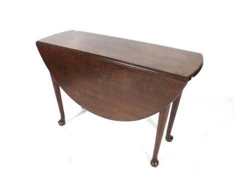 A Georgian mahogany drop leaf oval table. With rounded table edge, raised on tapering round supports on pad feet. Circa H71cm