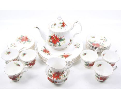 A collection of twenty piece Royal Albert Yuletide pattern tea dinner service. Including a tea pot, milk jug, sugar bowl, six