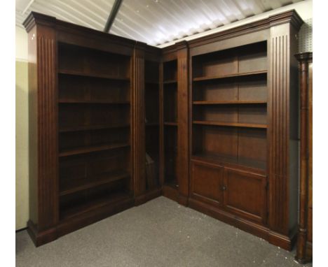 A contemporary antique style six-piece corner bookcase. With a moulded cornice, fluted columns (three removable), a two door 