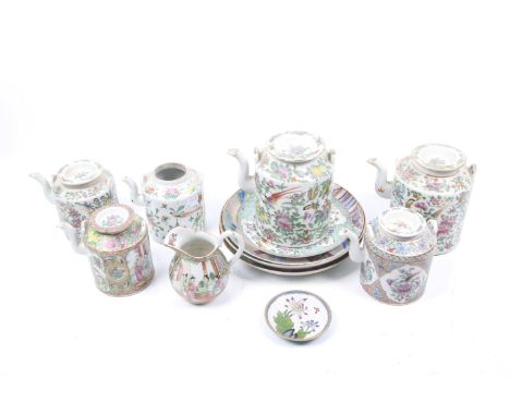 Eleven pieces of famille rose export ceramics and an enamel dish. Comprising teapots, plates and a jug, decorated with birds 