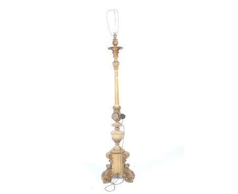 A carved gilt wood standard lamp. With a fluted column support and scrolling tripod base, H151cm (excluding fitting)
