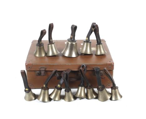 A vintage faux leather case containing thirteen hand bells and documents. With leather loop handles. Comprising: A , A+, B, C