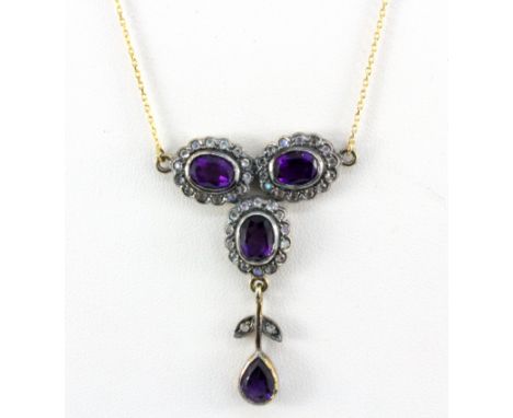 A 9ct yellow gold and silver amethyst and stone set necklace, L. 40cm.