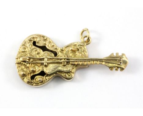 A 9ct yellow gold guitar shaped pendant, L. 3.5cm, W. 6.1g.&nbsp;