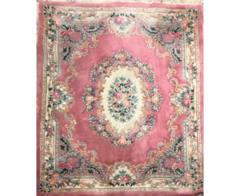 A large pink ground wash wool Chinese carpet with floral motif, 240 x 350 cms