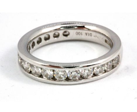 An 18ct white gold diamond channel set three quarter eternity ring, marked 750 and Dia.100 indicating 1ct of diamonds. (L).