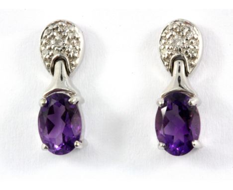 A pair of 9ct white gold amethyst and diamond set drop earrings.