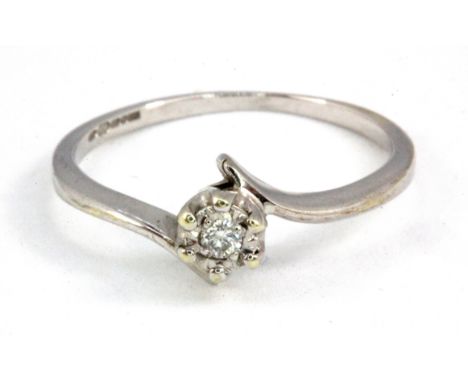 A 9ct white gold diamond set solitaire ring, (J.5).