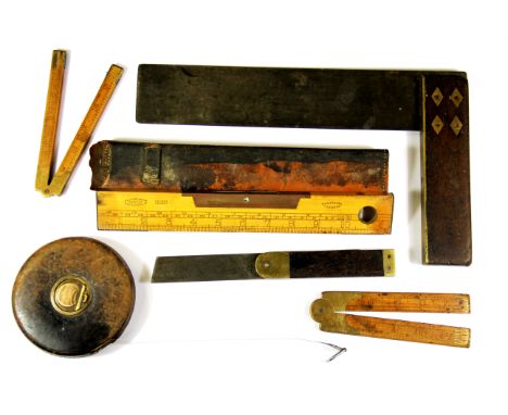 A group of vintage wooden rulers etc.