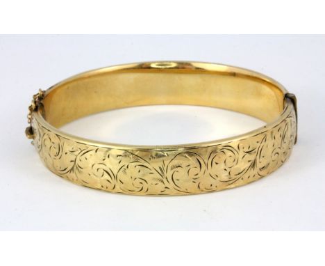 A 9ct yellow gold metal core bangle, Dia. 6cm.