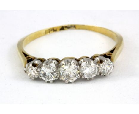 An 18ct yellow gold and platinum five diamond set ring, (M).