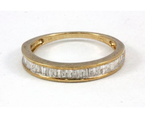 A 9ct yellow gold baguette cut diamond set half eternity ring, approx. 0.5ct, (R.5).