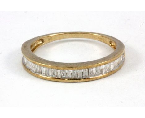 A 9ct yellow gold baguette cut diamond set half eternity ring, approx. 0.5ct, (R.5).