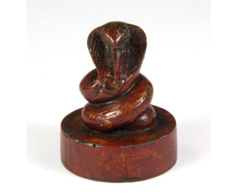 A Chinese red lacquered and gilt metal seal mounted with a snake, H. 6.5cm.