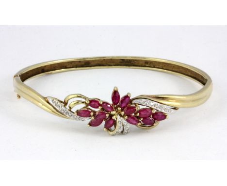 A 9ct yellow gold ruby and diamond set bangle.