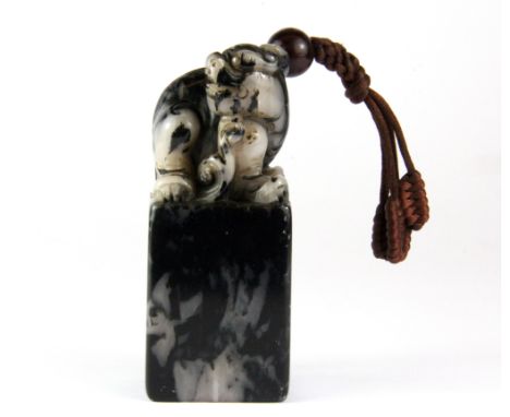 A Chinese carved soapstone scholars seal, H. 10cm with silk carrying cord.