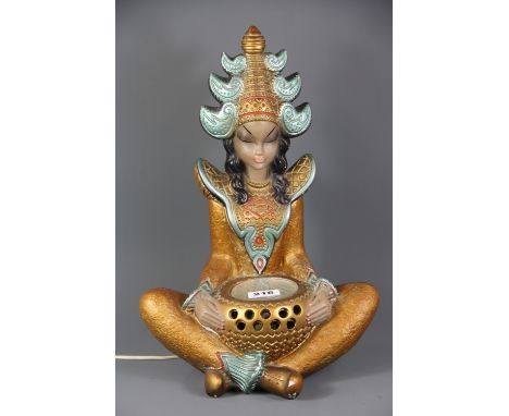 A 1950's plaster table lamp in the shape of a Siamese girl, H. 42cm.
