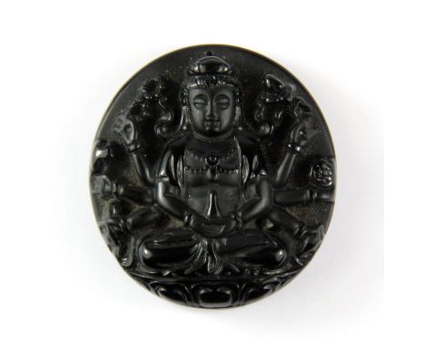 A Chinese carved obsidian amulet of a multi-armed Buddhist amulet, Dia. 4.5cm.