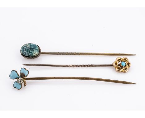 A 1900 enamel and paste stick pin, together with a Scarab stick pin and a 9ct wreath example (3)