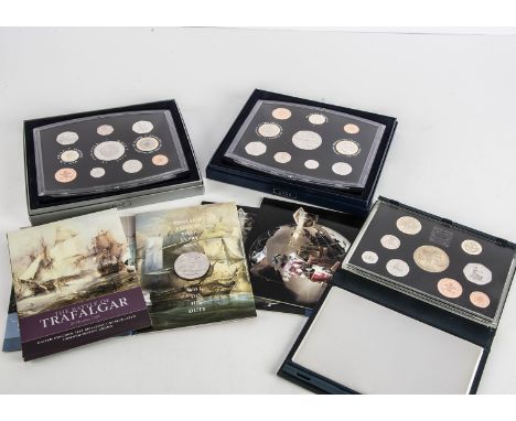 Eight Royal Mint UK proof sets, dated from 1996 to 2003, together with a Trafalgar crown, and two The Sunday Times Banknote a