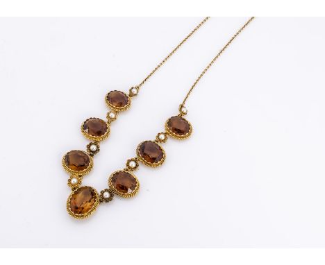 An Edwardian 15ct gold citrine and pearl fringe necklace, the graduated mixed oval cut citrines alternately set with flower h