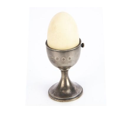 A novelty 1980s silver egg timer by Anthony Gordon Elson, 11cm, AF, realistically modelled as a silver egg cup and egg, the r