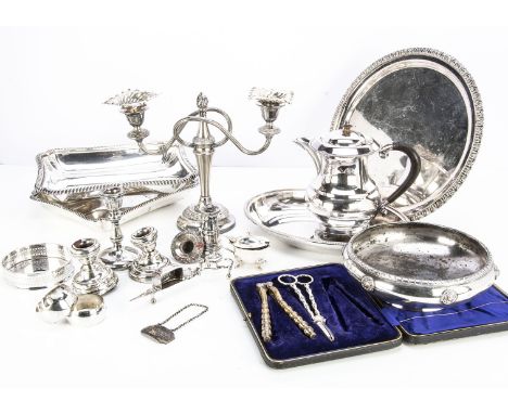 A collection of silver and silver plate, including a pair of silver candlestick sconces, a pair of short silver filled candle