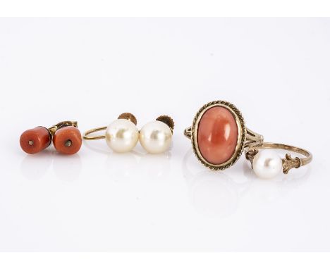 A 9ct gold coral dress ring, the oval cabochon in rubbed over setting, ring size O, together with a pair of stud earrings, a 