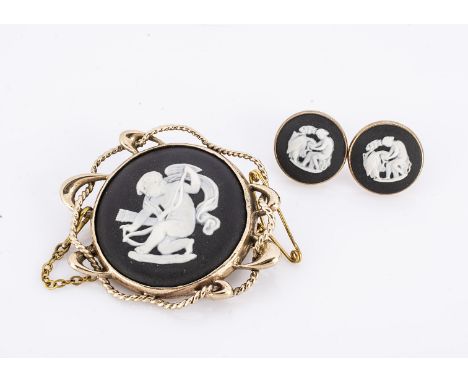 A contemporary 9ct gold black jasper brooch and earring set, the round panel depicting cupid, in an ornate frame, with a pair