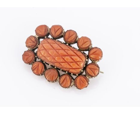 An early 19th century Italian coral brooch,  of rectangular shape, centred with a cross hatched coral panel, surrounded by ro