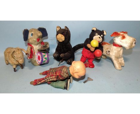 A collection of six clockwork toys: a Japanese cat playing the maracas, a black and white velveteen-covered cat, an elephant 