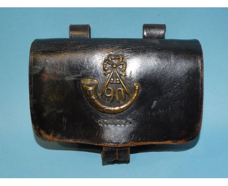 A vintage black leather military belt pouch bearing the brass insignia for the 90th Regiment of Foot (Perthshire Volunteers),