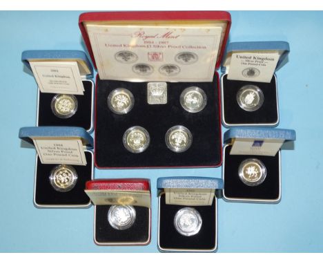 The Royal Mint, a collection of seven cased silver proof £1 coins, comprising: 1983, 1984-1987 four-coin collections, 1988, 1