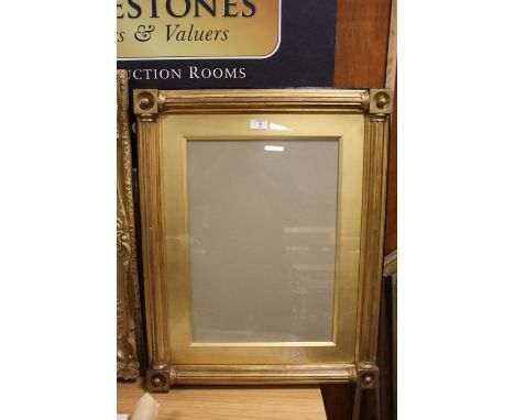 A 19TH CENTURY REGENCY STYLE GOLD FRAME WITH ARCHITECTURAL COLUMNS, with hollowed blocks with inset spheres on the corners, w