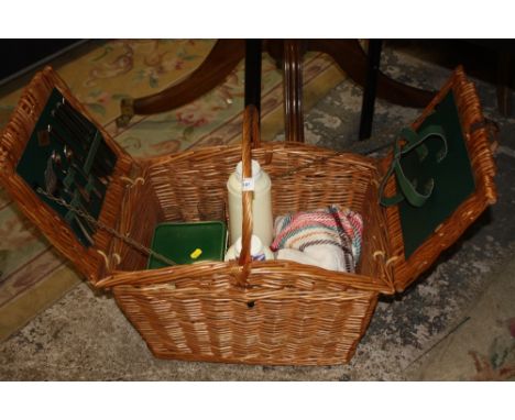 A WICKER PICNIC HAMPER AND CONTENTS TO INC A BLANKET, FLASK &amp; CUTLERY ETC