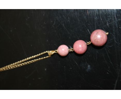 A 9 CARAT GOLD CHAIN WITH PENDANT DESIGNED AS THREE GRADUATING POLISHED STONES