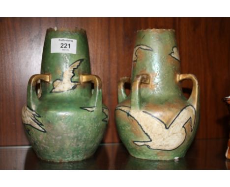 A PAIR OF QUAD HANDLED GREEN CERAMIC VASES DECORATED WITH BIRDS A/F  
