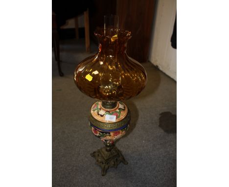 A VINTAGE CERAMIC AND BRASS OIL LAMP WITH SHADE