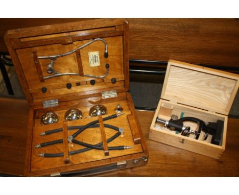 AN OAK CASED CAPAC BIN-AURAL VINTAGE STETHOSCOPE TOGETHER WITH A CASED MODERN MICROSCOPE
