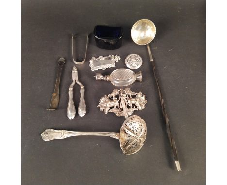 Mixed items to include a white metal Art Nouveau style buckle of a lady and flower form, a silver plated label, a white metal